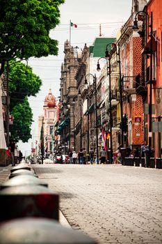 Vibrant street view showcasing colonial architecture in Puebla, Mexico.