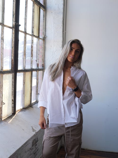 Model Posing in White Blouse and Cargo Pants