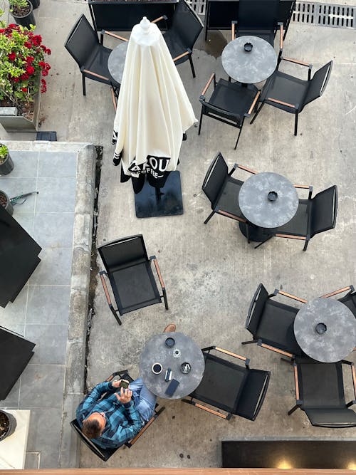 Man drinking coffee in coffee house and using his phone 