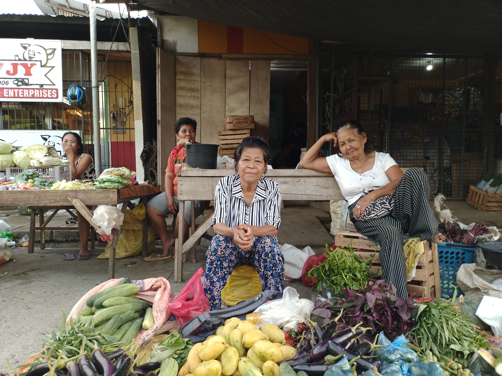 Women selling fresh produce at a street market in Nasipit, Philippines