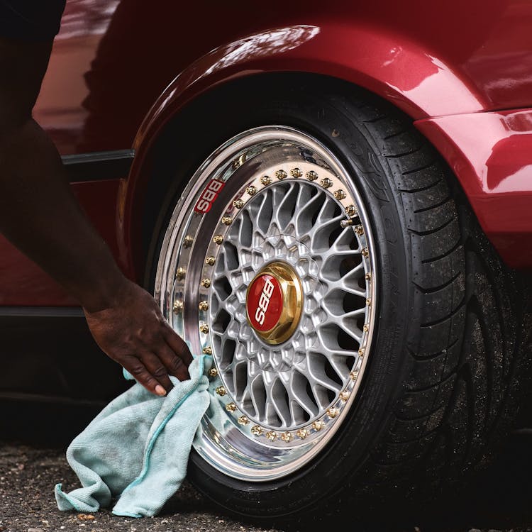 Close-up Of Man Cleaning The Rim