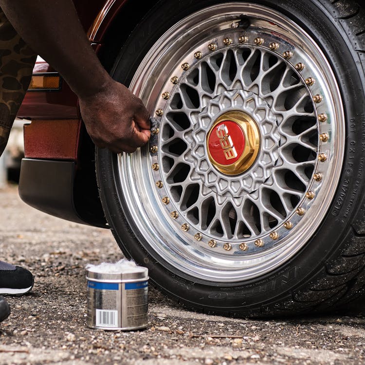 Close-up Of Man Cleaning The Rim