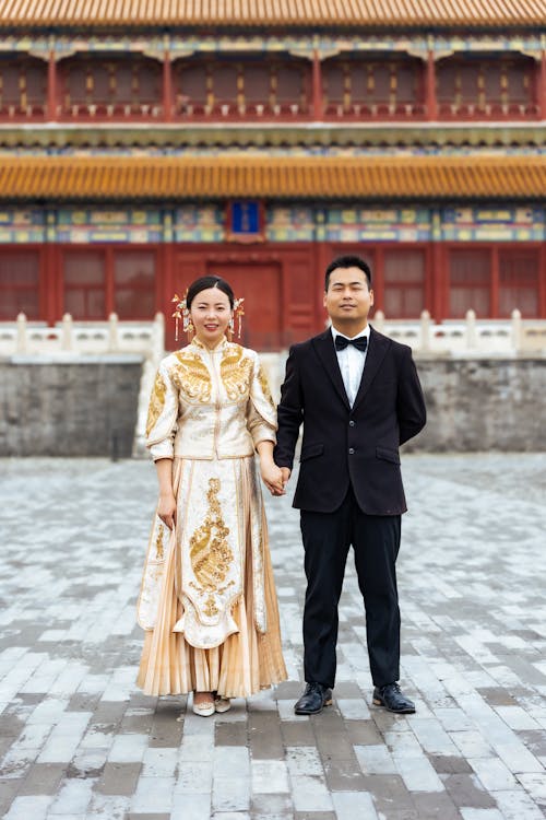 Newlyweds in Tuxedo and Traditional Dress