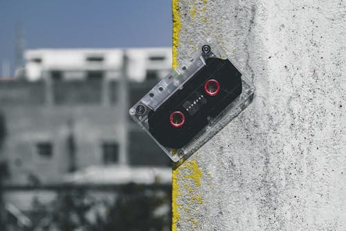 Clear and Black Cassette Tape on Gray Surface