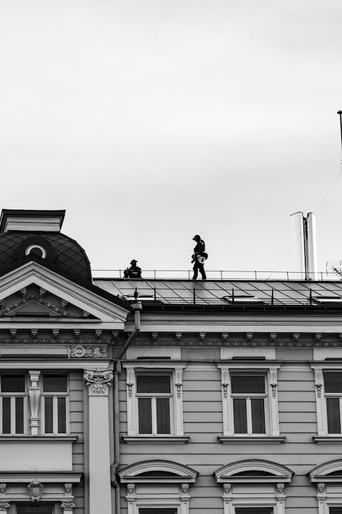 People Walking on a Roof 