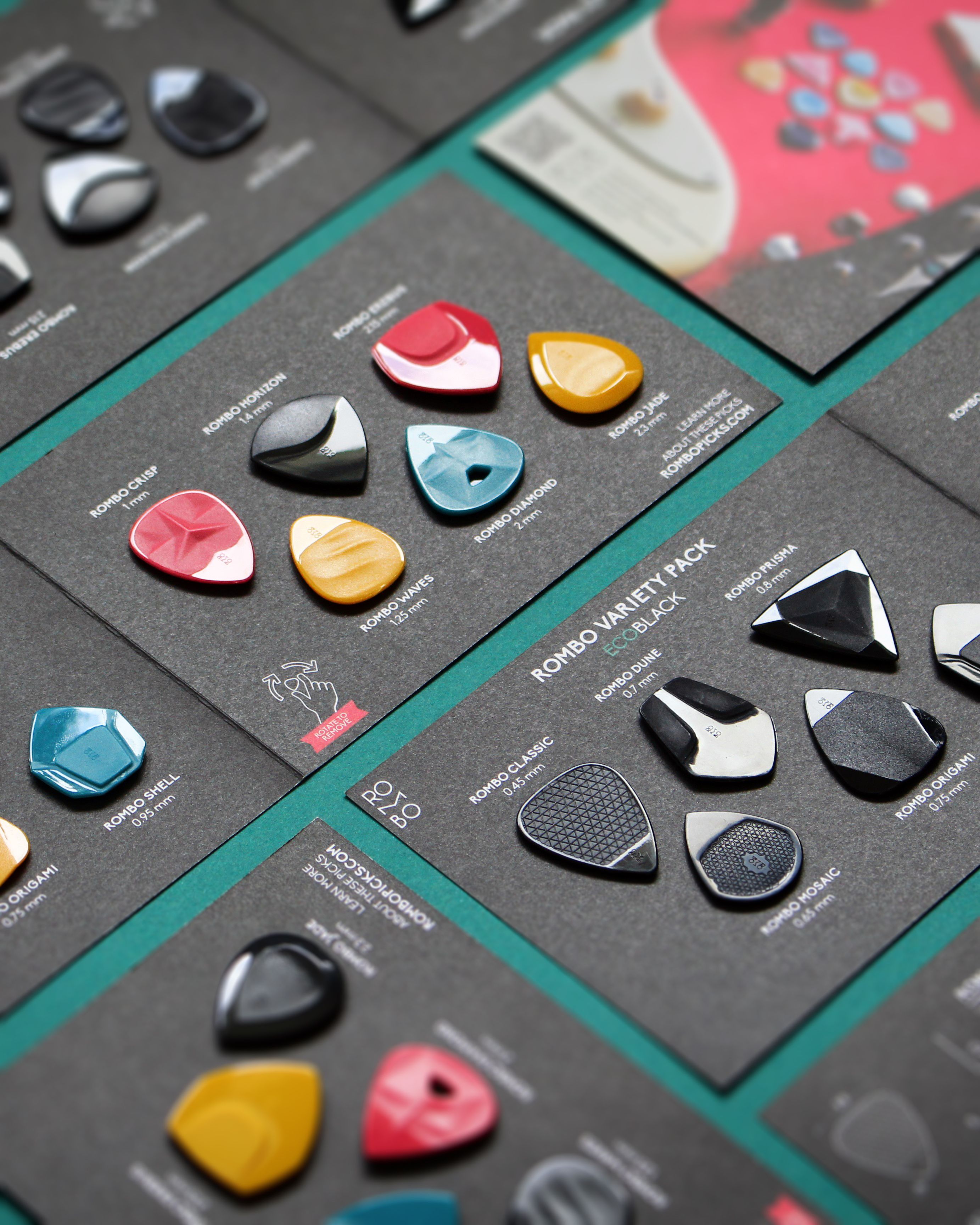 A neatly arranged assortment of colorful guitar picks on display cards, perfect for music enthusiasts.