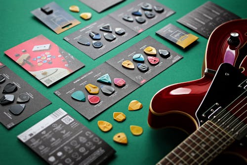 Guitar and Picks on Green Background