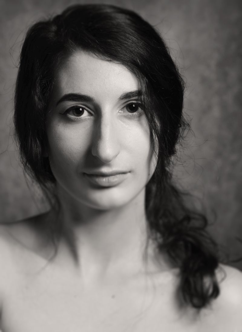 Black and white portrait of a woman with long sleek hair