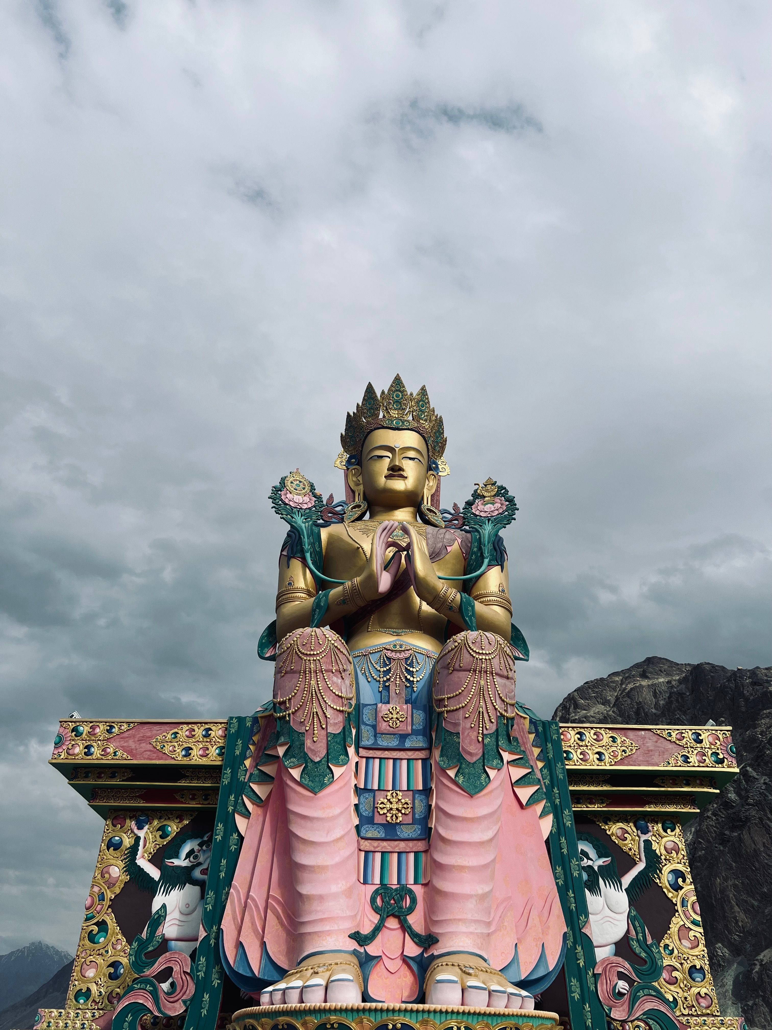 Stunning Buddha statue at Diskit Monastery in Leh, showcasing vibrant colors and intricate details.