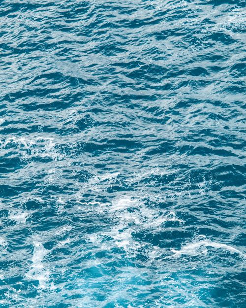 Free High-angle view of wavy blue ocean water showcasing nature's beauty in Tintagel, England. Stock Photo