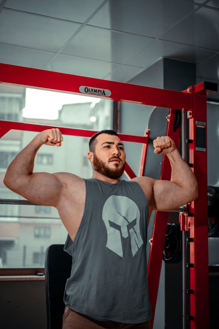 Man Showing Off Muscles At Gym