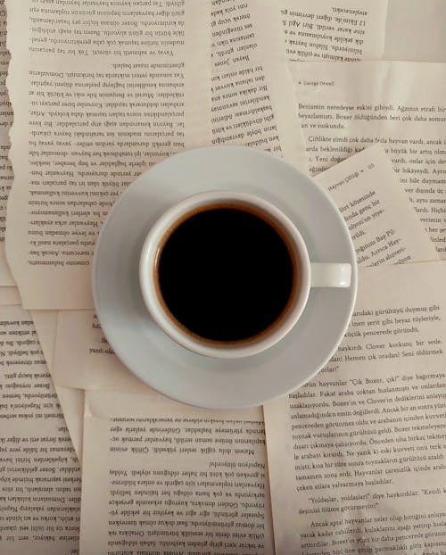 Free Coffee on a Book Pages Stock Photo