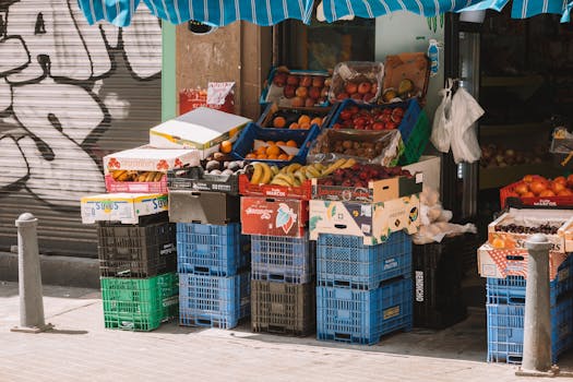 Colorful fruit stand on a sunny Valencia street, showcasing fresh produce in a local market.