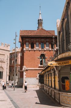 Scenic view of historic architecture on a sunny street in Valencia, Spain.
