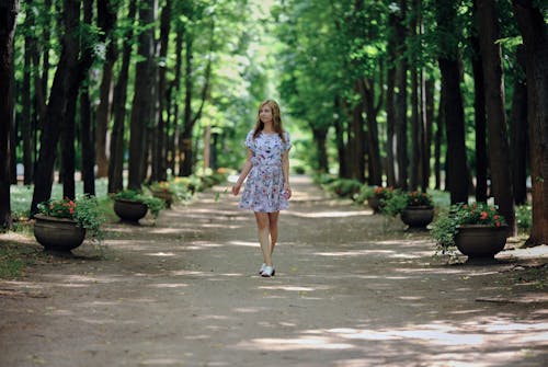 Woman Walking on a Path in Forest