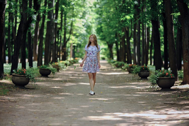 Woman Walking On A Path In Forest