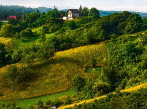 Free Idyllic landscape in Samobor, Croatia, featuring lush green hills and a solitary house. Stock Photo