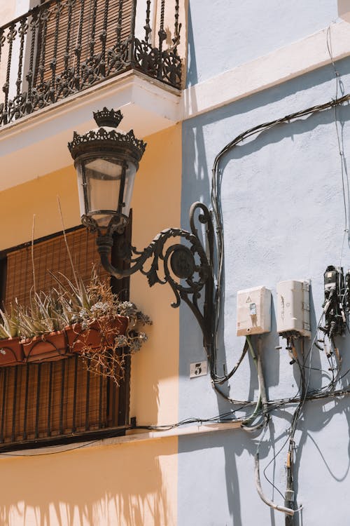 An Antique Lantern Attached to an Apartment Building in City 