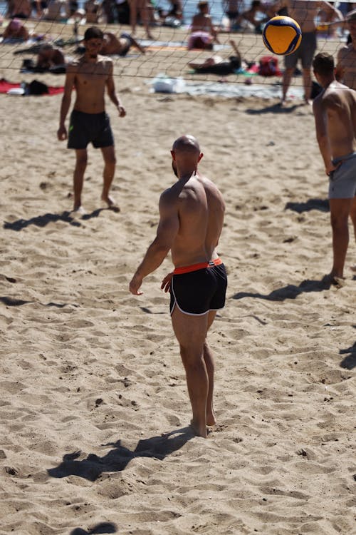 Tourists Playing Beach Volleyball