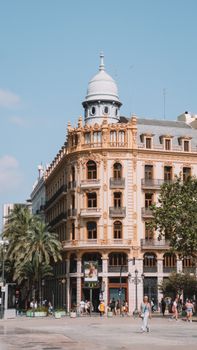 Historic building in Valencia, Spain showcases traditional architecture under a clear summer sky.