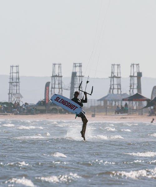 Man Kitesurfing on Coast