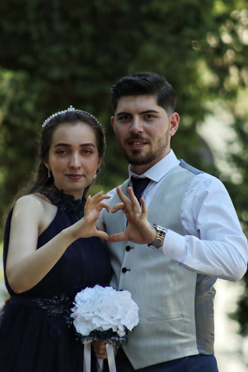 Groom with Bride Making Heart Shape