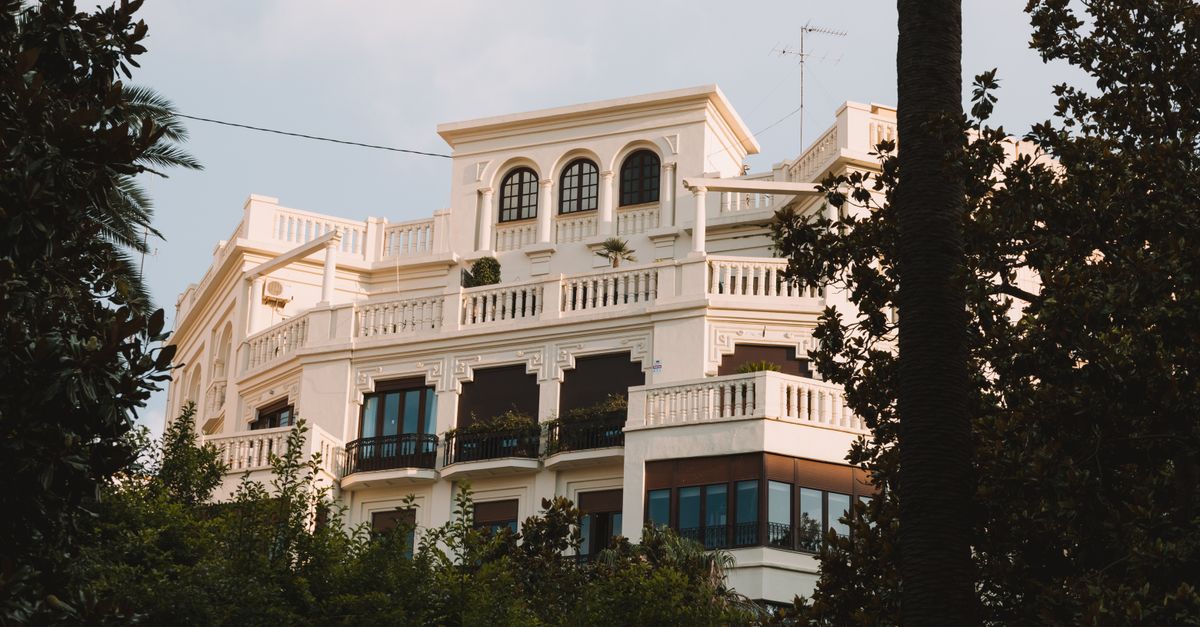 A stunning villa in Valencia, Spain, surrounded by greenery and showcasing classic architecture.