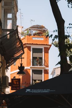 A vibrant residential building with balconies in Valencia, Spain captured on a sunny day.