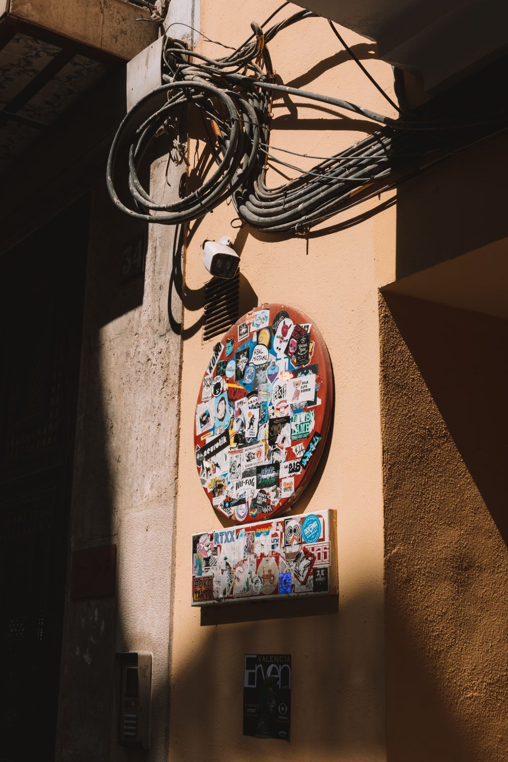 Sign with Stickers on the Building Facade · Free Stock Photo