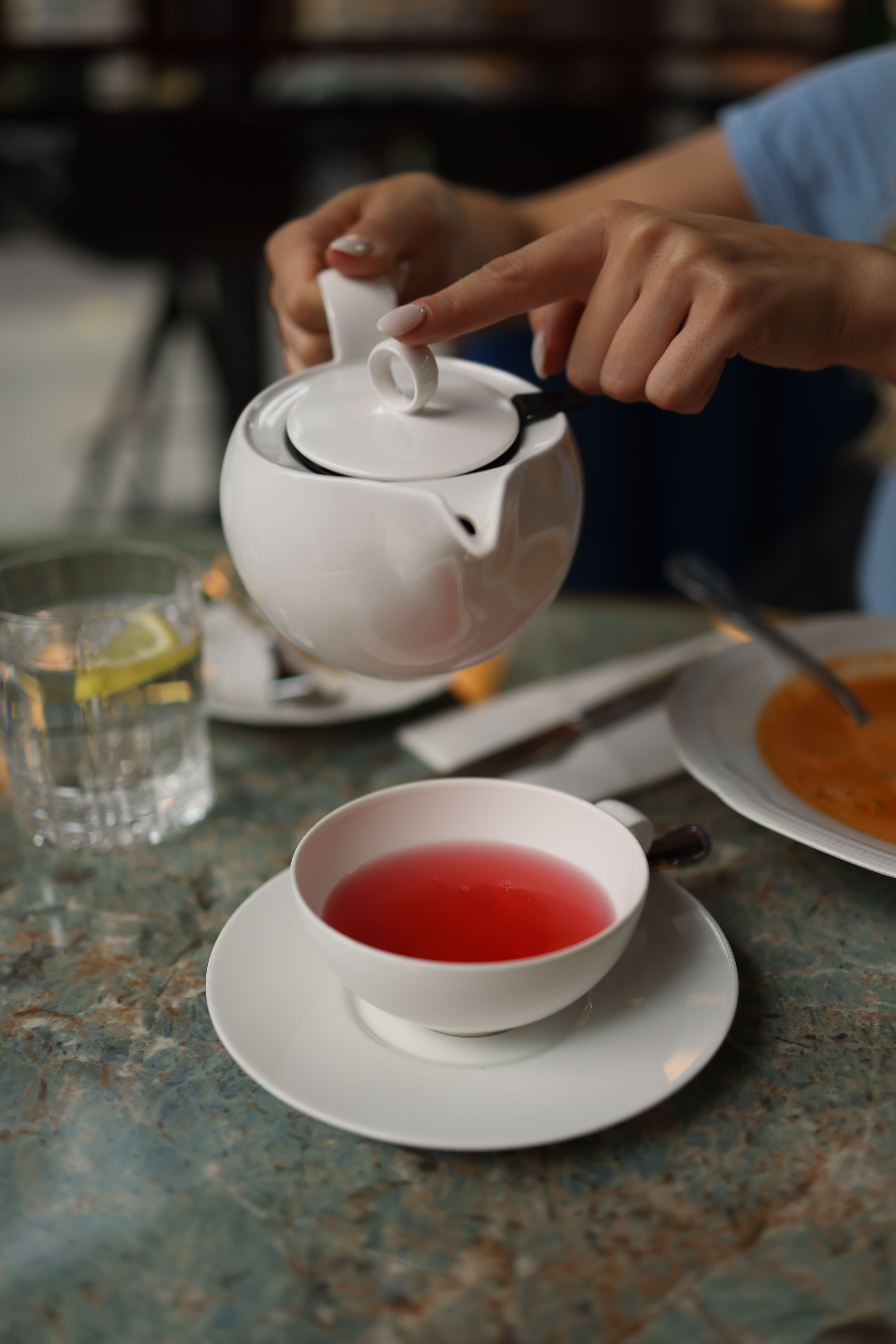 A cup of warm fennel tea on a table in the morning sunlight.