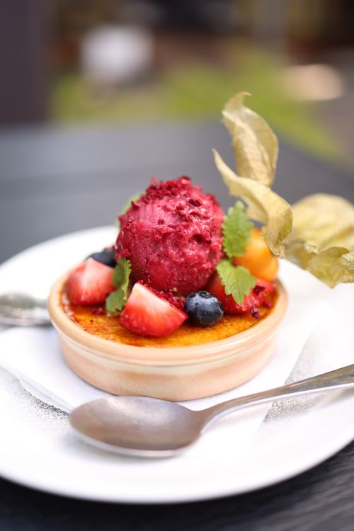 Free A close-up of a vibrant fruit-topped dessert with a spoon on a plate, ideal for food photography. Stock Photo