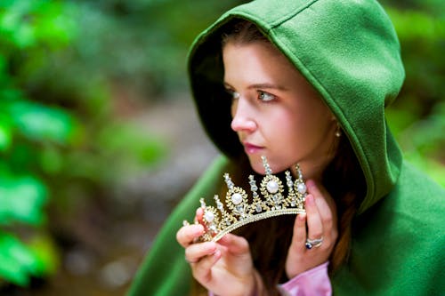 Fairytale Princess with Crown and Green Cloak in the Woods