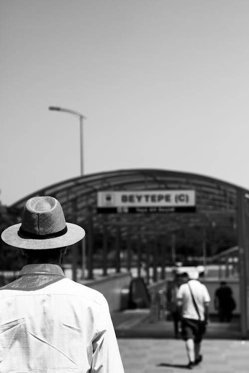 Man in Front of Metro Station in Black and White