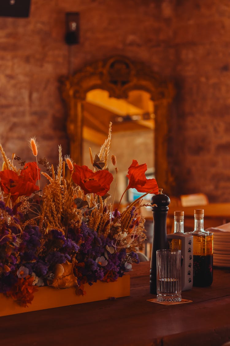 Glass Of Water, Grinder With Pepper And Bottles Of Olive Oil On Counter