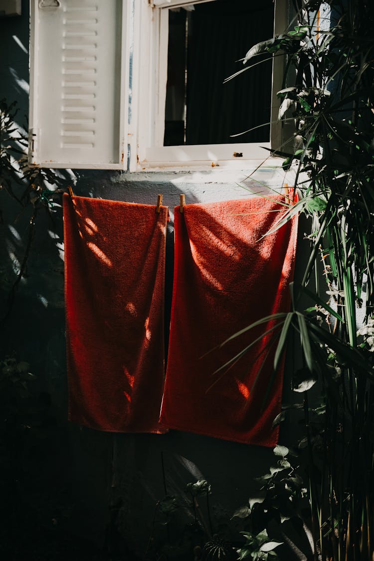 Red Towels Hanging In A Garden