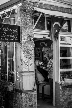 Capturing a traditional moment in a historic barber shop in Ayvalık, Türkiye.
