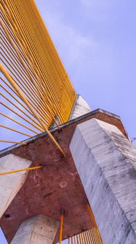 Upward view of Rio Negro Bridge architecture against a clear sky in Manaus, Brazil.