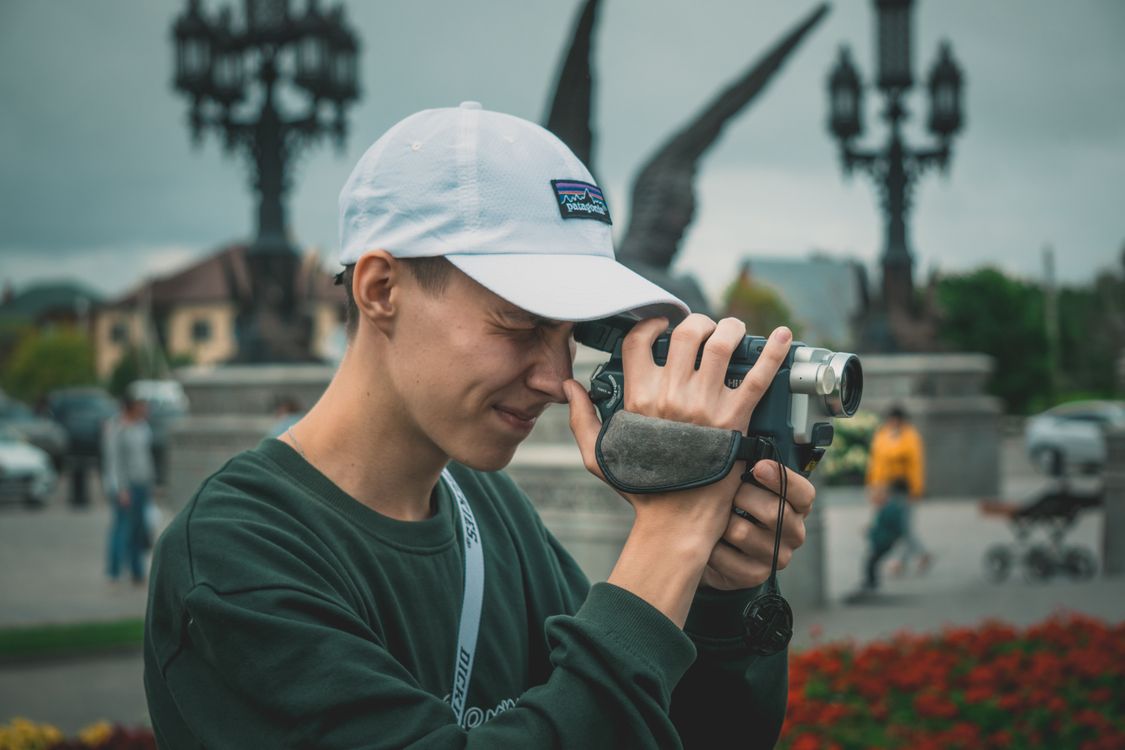 Man Using Camera Monaco Young Man Using a Video Camera · Free Stock Photo