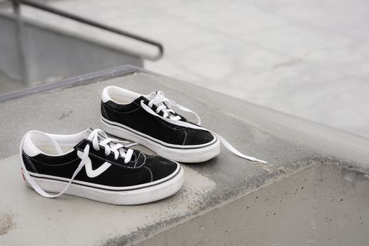 Classic black sneakers on a skate park ramp in Los Angeles, CA.