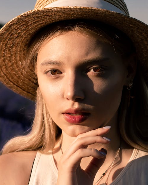Young Blonde Woman Posing in a Straw Hat
