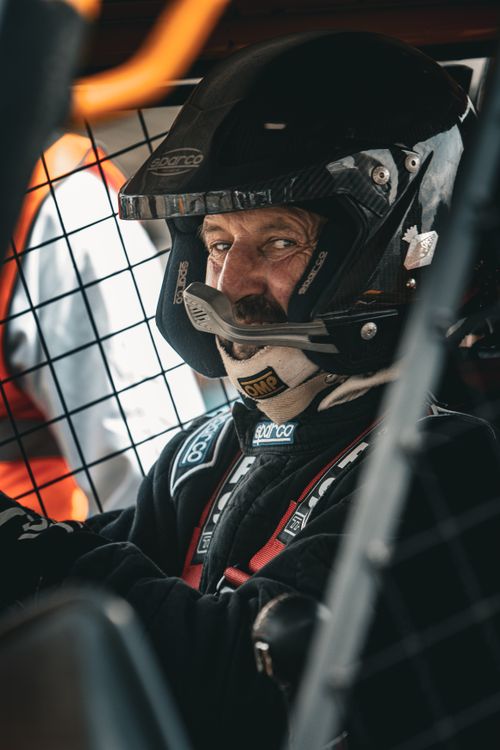Free Focused race car driver in full gear, ready for action. Stock Photo