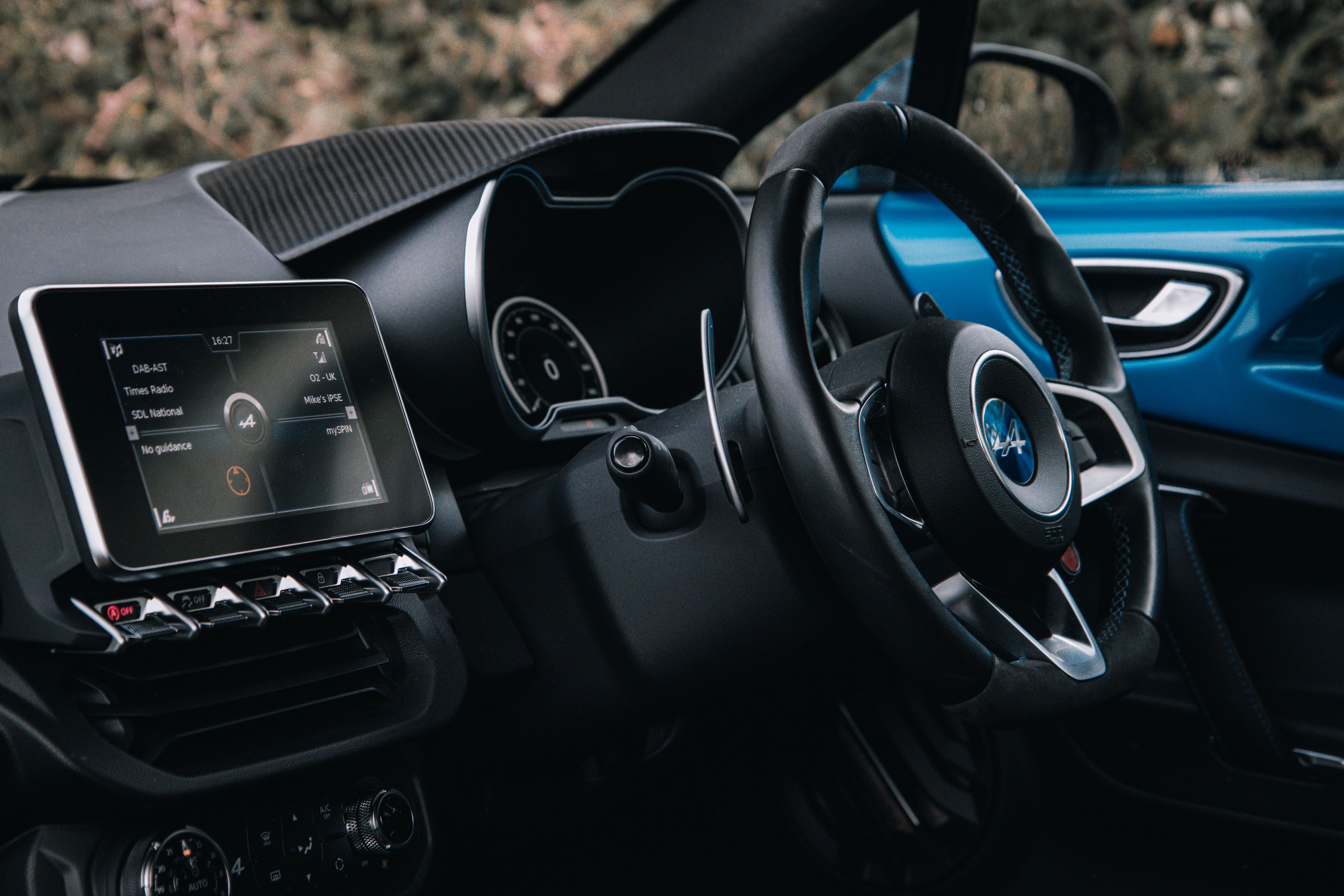 Close-up of a sleek car interior showcasing the dashboard and steering wheel. - 8 Under $15 Health and Wellness Finds That Make Daily Self-Care Simple
