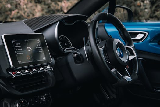 Close-up of a sleek car interior showcasing the dashboard and steering wheel.