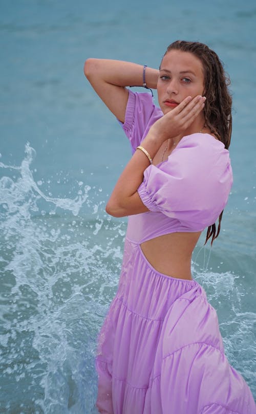Woman in Purple Dress on Sea Shore