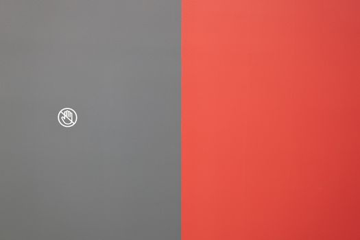 Elegant minimalist composition featuring contrasting red and gray color blocks with a hand icon.