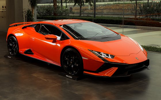 Stunning orange Lamborghini Huracan sports car displayed indoors, showcasing luxury and style.