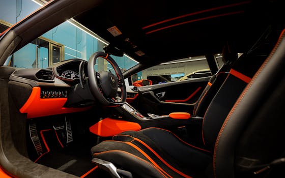 Explore the luxurious, high-tech interior of a sleek sports car with leather seats and illuminated dashboard.