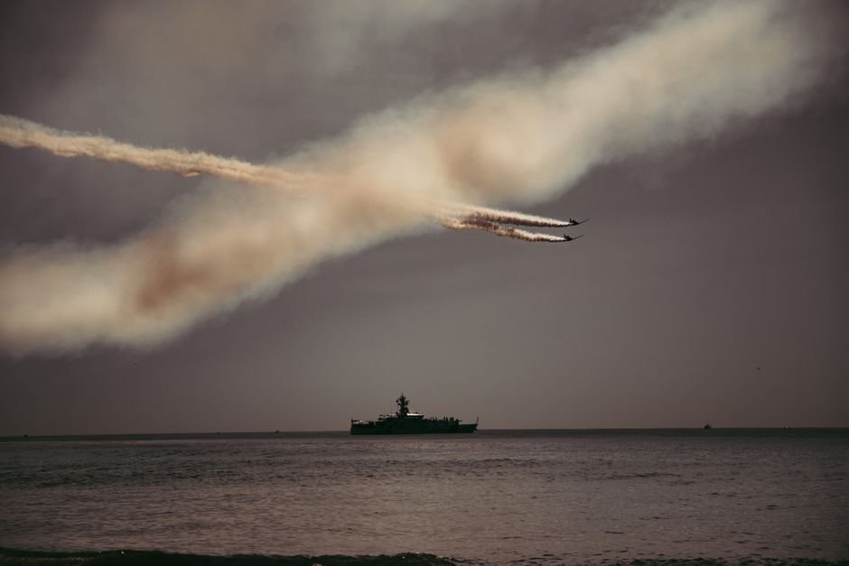 Spectacular airshow in New York Harbor with fighter jets and a ship.