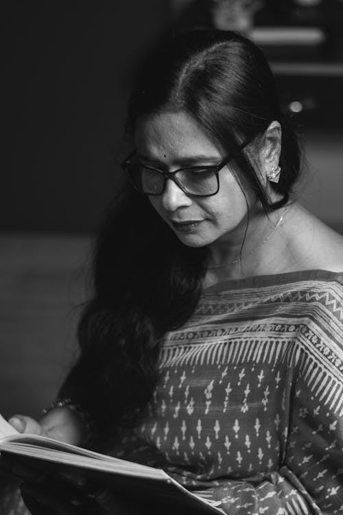 Black and White Portrait of a Brunette Woman in Saree Reading a Book