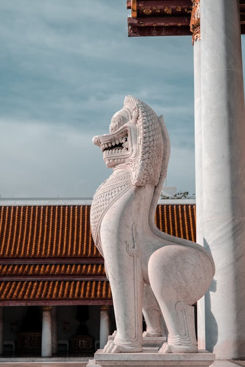 A statue of a lion in front of a building